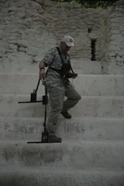 Robert Leonard descends the steps of an ancient Mayan structure with a GPR device in El Mirador, Guatemala.