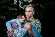 Maciej Mikolajczyk as Piotr 'Rambo' Wojcik and child