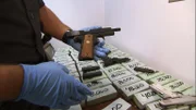 Nogales, AZ: A CBP officer unloading confiscated and packaged weapons. Some of the items seized will be used to conduct research on the cartel which was running the smuggling operation.