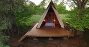 The completed Riverside Retreat features an A-frame cabin hidden amongst the trees, as seen on Built For The Weekend.