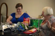 Amy smiling and meal prepping with friend Nikki.