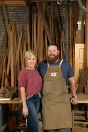 As seen on Home Town, Ben and Erin Napier (C) work on finishing a custom desk in their workshop located in Laurel, MS. (workshop, portrait)