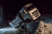 Odda, Norway - A truck has driven out of the road. It has one wheel on the road and two wheels in the ditch.