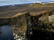 Dr. Robert Ballard standing at the cliff edge on the Reykjanes Peninsula.