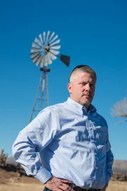 Ken Cage in front of a windmill.