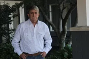 Carl Sr stands outside.