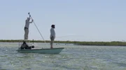 Jay Johnson and Brian Jill fishing from a boat in the Bahamas.