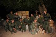 Rio Grande City, Texas, USA: Border Patrol Agents pose in front of bundles of marijuana.