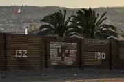 SAN DIEGO, CA, USA: A fence crafted from an old military landing mat separates Tijuana from San Diego. The San Ysidro border crossing is the busiest in the world, with over 40 million people entering the U.S. through the port in 2005 alone.