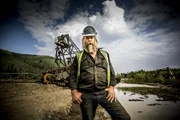 Tony Beets standing in front of the dredge.