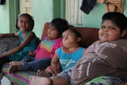 Amisha, Yogita and Harsh Nandwana with their sister Bhavika Nandwana sitting down on the couch.