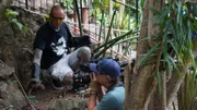 Durban, South Africa - Simon Keys with gloved hands holding a Mozambique spitting cobra (Naja mossambica) that he had safely extracted from inside an old tree stump. The gloves are specially designed, heavy-duty gloves which protect snake handlers from possible snake bites. (Earth Touch LTD/Daniel Philogene)