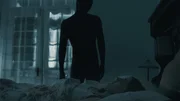 A person in black looking at a woman