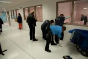 El Paso, TX: Officers searching apprehended men. Suspects and persons caught committing criminal activities are held at detention centers where they wait for a hearing before an immigration judge.