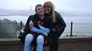 Nick Zackorak  and Silvia Corrain smile by the Golden Gate Bridge.