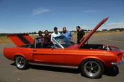 The Carlo Family check out the completed Mustang with Carlos.