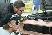 Mark and Nick look at the engine of the Mustang.