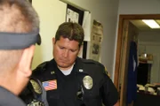 Laredo, TX: K-9 Officer Rolando San Miguel of the Laredo Police Department listens as team members from the Laredo NARC Unit discuss the coming days raid.