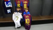 Callum Jarram and Kian Jarram holding up football shirts in the changing room.