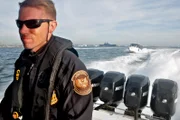 SAN DIEGO, CA, USA: A border patrol agent drives during a "fast boat drill" on the water near the San Diego-Tijuana border. In 2009, with heightened land enforcement fueling human smuggling by sea, the border patrol introduced this fast, 43-foot boat for pursuit of high-speed vehicles.