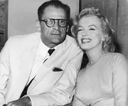 American actress Marilyn Monroe (1926 - 1962) with her husband, playwright Arthur Miller at London Airport, 14th July 1956. Monroe is in London to begin filming 'The Prince and the Showgirl' with Laurence Olivier.
