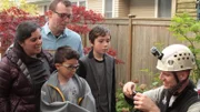 Shaun Sears holds Snow in a cat bag, presents him to the Heinrich family: Peter, Angie, Aden and Zane.