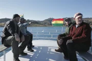 Josh Gates and the crew head towards their next destination by boat on Lake Titicaca.