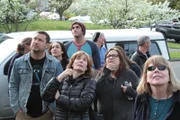 The neighborhood group stares up into the trees, observing Shaun embarking the "Snow" rescue.