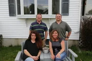 Joanne, Kat, Randy, and Gary in front of house.