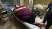 Ashley laying on a hospital bed before her surgery.