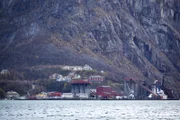 Odda, Norway - Industry, houses and mountain in Odda. Shows how brutal the mountains are. Anything can happen with those houses if the weather is bad enough.