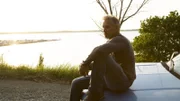 Glenn contemplates the American Dream sitting on hood of his truck at dusk.