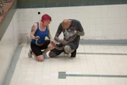 DURBAN, SOUTH AFRICA- Simon Keys and Susan Gillett examining an injured Black mamba (Dendroaspis polylepis) in an empty pool. Simon and Susan catch snakes in human habitations in and around Durban and translocate them to safer areas where they are less likely to come into contact with people.