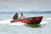 Hubert (Christian Tramitz, rechts) und Staller (Helmfried von Lüttichau) beobachten vom Boot aus das Anwesen von Fred Holzinger.