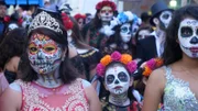 Locals with painted faces for the Dia de los Muertos celebration in Mexico.