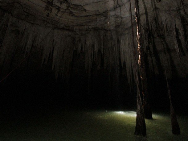 Pisté, Mexico - Inside view from cenote Holtun. The Mayan got their water from these cenotes, which were created when the limestone surface collapsed, exposing pools that descend down hundreds of feet.