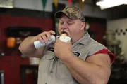 Steve McGranahan eating a donut with spray cheese.