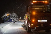 FINNSNES, Norway - Truck transporting cars from front. Rescue truck in the foreground. (Photo Credit: National Geographic Channels)