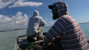 Thad Robison and Brian Jill on a boat in the Bahamas.