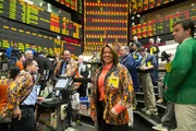Picture Shows: Wide shot of Virginia McGathey surrounded by traders and brokers on the Chicago Board of Trade grain futures floor