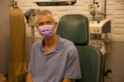 Leonard sits in the exam room waiting to meet Dr. Sandra Lee.