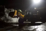 San Diego, CA: A forklift at night. The Customs and Border Protection agency ensures that all seized contraband and vehicles used to transport smuggled goods are completely destroyed.