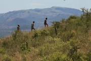 Blurry shot of Angel, Steven, and Ryan walking up a hill in the distance.