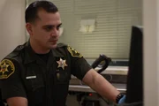Deputy Nava going through booking process.