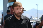 Chuck Norris looks at the truck.