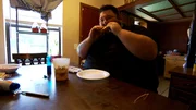 Gideon eating food at the table.