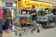 Joyce and her son with full carts.
