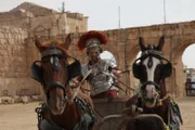 Josh Gates steering a chariot dressed as a Roman centurion in Amman, Jordan.