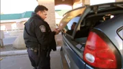 A Customs and Border Protection officer inspecting a car at the border to prevent the smuggling of drugs, people, money and weapons from Mexico.
(Photo Credit: © NGT)