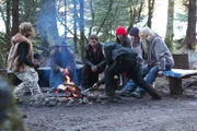 The Brown family gather around the fire.